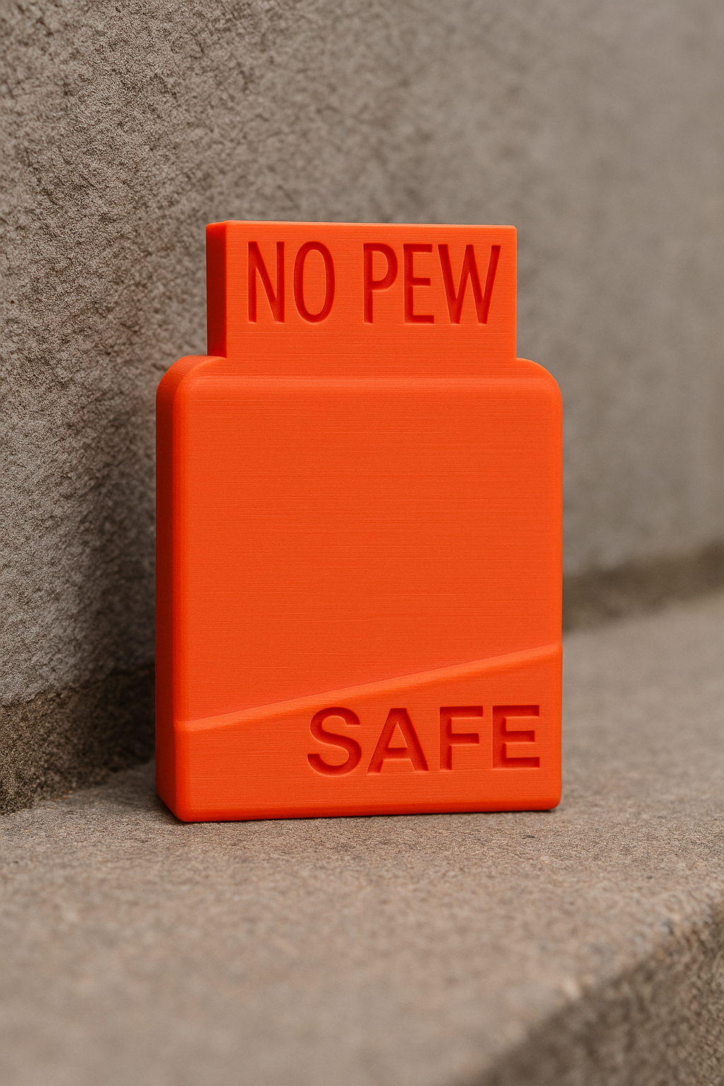 Close-up of an orange AR-10 magazine safety and chamber flag
